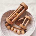 Five handmade montessori mateirals made from birch hardwoods in a basket.