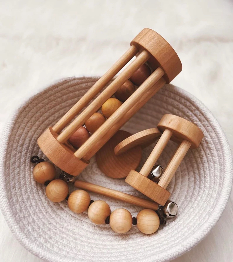 Five handmade montessori mateirals made from birch hardwoods in a basket.